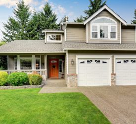 Curb appeal. American house exterior with double garage, concrete floor porch and well kept lawn. Northwest, USA